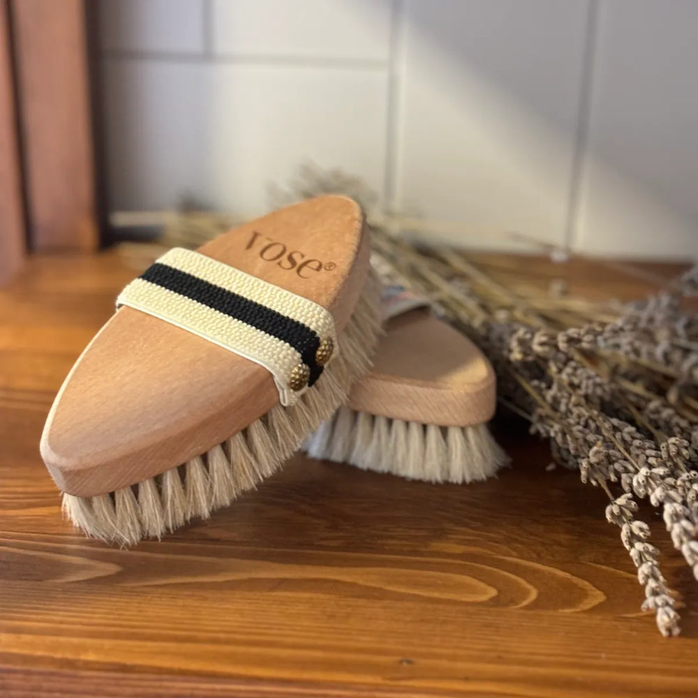 horse hair dry body brushes on a shelf with dry lavender in the background