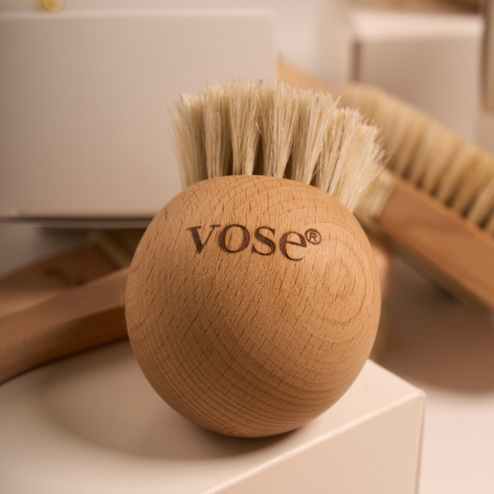 Wooden horse hair dry face brush with bristles on a white surface, featuring the brand 'vose'.