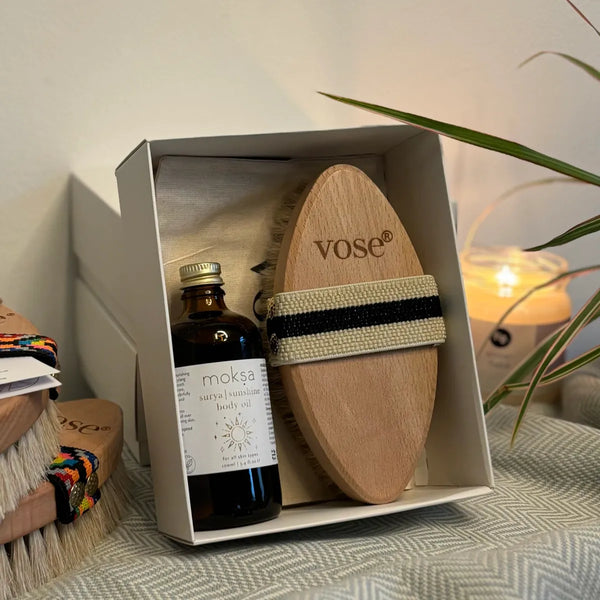 A gift set consisting of an organic body oil and horse hair body brush on display