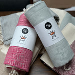 100% organic cotton herringbone patterned Turkish Towel in light blue colour on a table with different coloured towels
