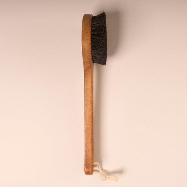 Black horse hair body brush with long handle side view