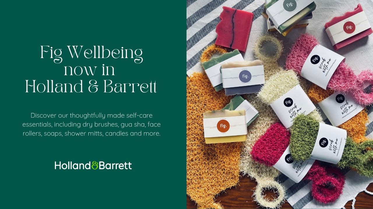 Promotional graphic for Fig Wellbeing by Holland & Barrett, showing a dark teal left panel with white text and a right panel with assorted packaged self-care items and textured bath/body accessories arranged on fabric.